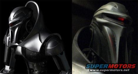two robot heads side-by-side, one black, one silver with red eyes. Supermotors logo at bottom right