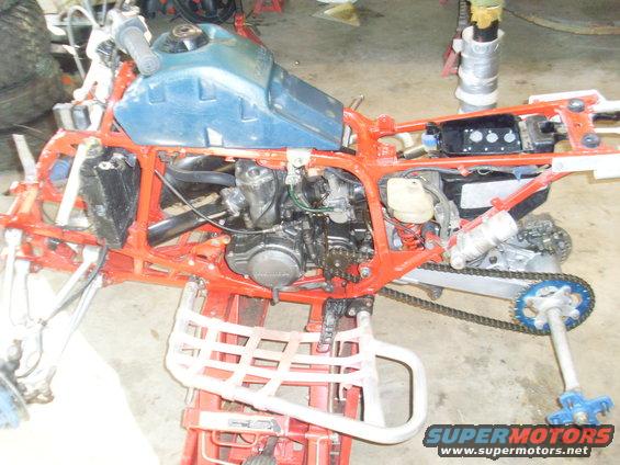 1987 Honda 250 R three-wheeler, side view, orange frame, blue gas tank