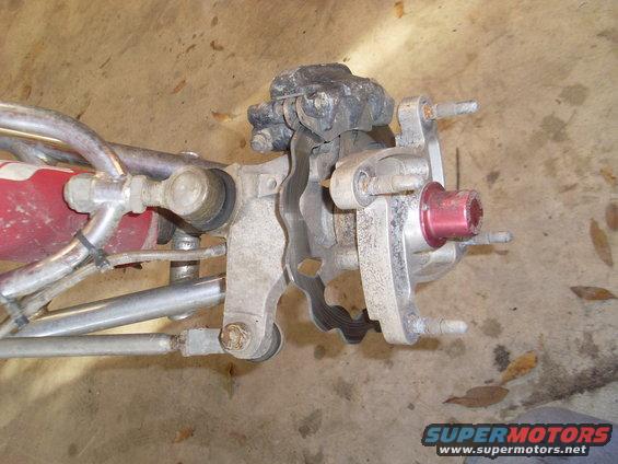 ATV front wheel hub with brake caliper and suspension components