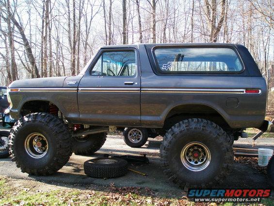 Lifted 1978 Ford Bronco with oversized tires and aftermarket wheels, parked outdoors