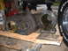 1978 Ford Bronco - A transfer case is shown resting on wooden blocks in a garage setting.