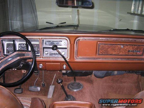 1978 Ford Bronco interior showing dashboard, steering wheel, radio, and gear shifters