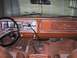 1978 Ford Bronco - The interior of a 1978 Ford Bronco displays its dashboard, steering wheel, and dual gear shifters.