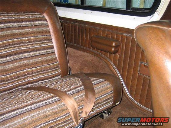 1978 Ford Bronco interior showing striped seat and brown door panel with armrest
