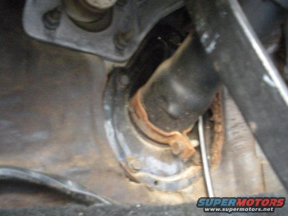 close-up of rusty steering column bracket and shaft