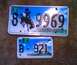 1999 Ford Crown Victoria - Two Wyoming license plates are displayed, one larger than the other, both a bucking horse and blue sky.