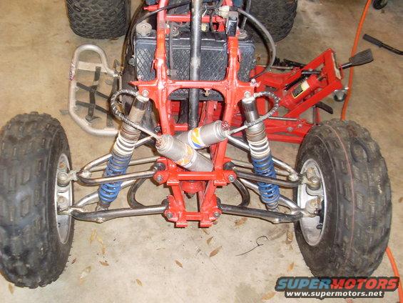ATV front suspension with red frame and dual shocks