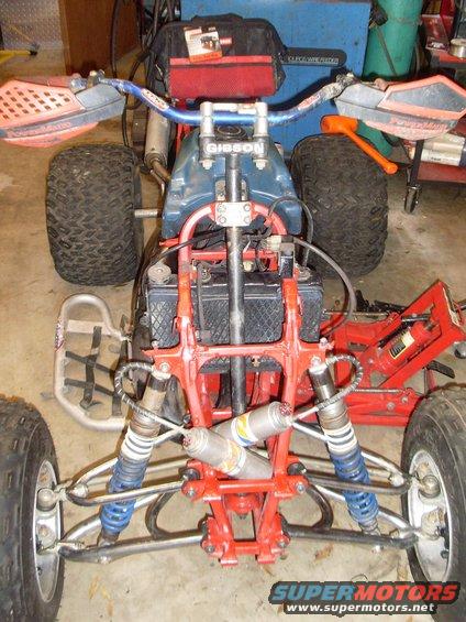 ATV front suspension and handlebars with 'GIBSON' visible on stem