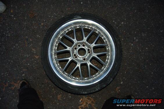 aftermarket alloy wheel with tire on asphalt