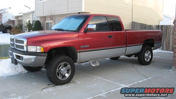 Red Dodge Ram 2500 pickup truck parked on a driveway