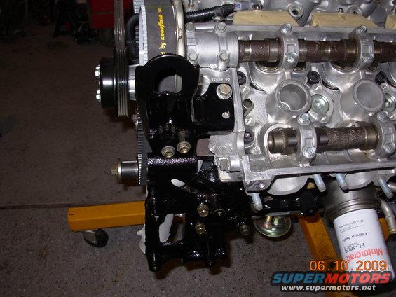 Engine block with black mounting bracket and oil filter. Date stamp reads 06.10.2009