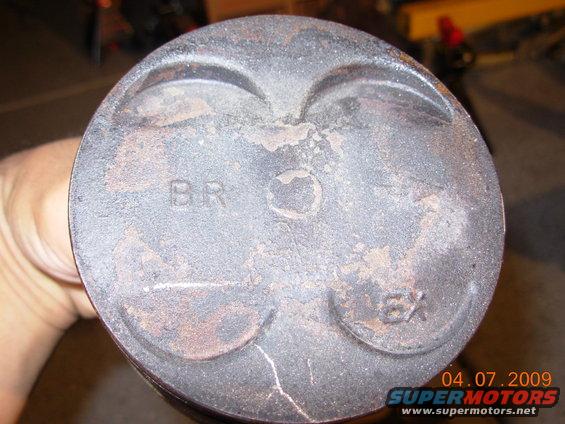 close-up of engine piston with markings BR and EX