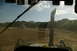 1986 Ford Bronco - Construction site scene with heavy machinery and a truck under a partly cloudy sky.