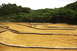 1986 Ford Bronco - RC car navigating a dirt track with black tubing defining the course.