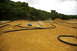 1986 Ford Bronco - RC cars kick up dust as they navigate a winding dirt track.