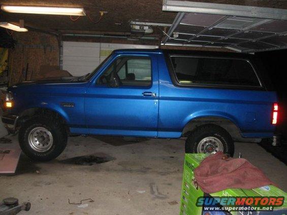 Blue 1992 Ford Bronco parked inside a garage