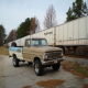 1967 Ford F-250 pickup truck, 3q-front view, parked next to a train car