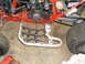 1987 Honda 250 R - Close-up view of an ATV's engine and footpeg, showing the "X-Plus" branding on the footpeg.