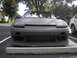 1991 Nissan 240SX - Front view of a 1991 Nissan 240SX with pop-up headlights and an aftermarket bumper.