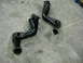 1978 Ford Bronco - Two black exhaust headers are shown resting on a concrete surface.