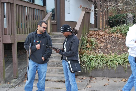 People with shotguns outside a building