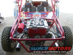 Rear view of red dune buggy, exposed V8 engine, off-road tires, SuperMotors.net logo