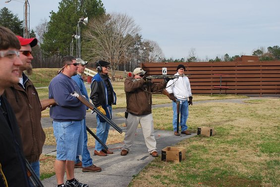 People practice shooting at a clay pigeon range