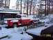 1969 Ford Mustang - Old red pickup truck sits in the snow during winter.