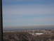 1991 Ford Bronco - A wide view of a landscape rolling hills, scattered buildings, and a hazy sky, suggesting a distant urban or suburban area.