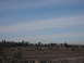 1991 Ford Bronco - A wide shot captures a distant town with scattered buildings and trees against a hazy sky.