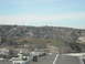 1991 Ford Bronco - A wide shot captures a densely populated hillside community under a clear blue sky, with a town and construction visible in the foreground.