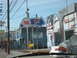 1991 Ford Bronco - A white car with an orange stripe and license plate 6229 is visible in the foreground, parked near a Coors Light drive-thru sign.