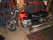 2002 Buell Lightning w/Fairing - A motorcycle with a flame-painted fuel tank is parked indoors.