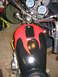 2002 Buell Lightning w/Fairing - Close-up of a motorcycle's fuel tank and handlebars, flame decals and dual gauges.