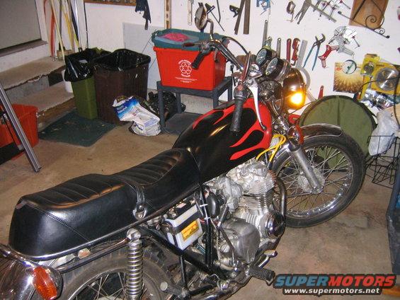 Motorcycle with black seat and red and black flame decals on the fuel tank