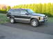 1998 Chevrolet Tahoe - This Chevrolet Tahoe is parked on a driveway with a line of hedges behind it.