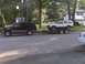 1998 Chevrolet Tahoe - A dark 1998 Chevrolet Tahoe is seen towing a trailer carrying a white Jeep Cherokee.
