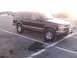 1998 Chevrolet Tahoe - This SUV is parked in a lot with a sun glare in the background.