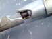 1992 Ford F-350 - Close-up of a broken shifter cable housing, revealing internal damage and exposed wiring.