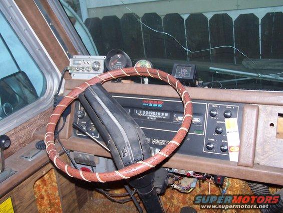 1974 Dodge RV/Conversion Chassis interior with wood paneling and aftermarket radio