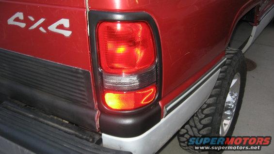 Red 1997 Dodge 2500 pickup truck rear quarter panel with 4x4 decal and taillight