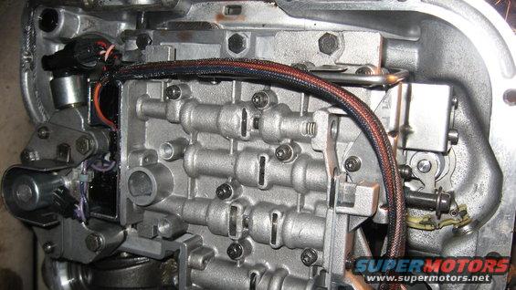 Close-up of an automatic transmission valve body with solenoids and wiring
