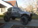 1984 Ford Bronco II - This heavily modified pickup truck features a custom roll cage and massive off-road tires, suggesting it's built for extreme terrain.