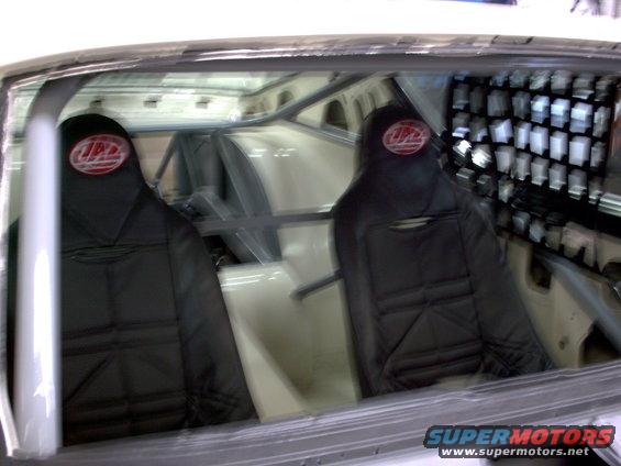 Interior view of racing seats and roll cage in a car