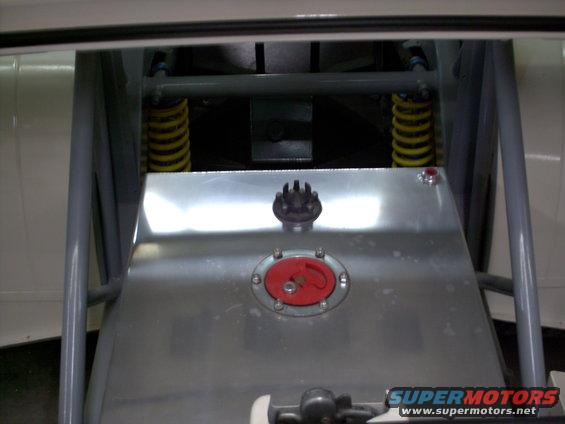 Close-up of a fuel cell with a red cap and a black cap on top, yellow springs and gray bars visible