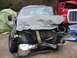 1995 Ford Bronco - This truck sustained significant front-end damage, with a red truck visible behind it.