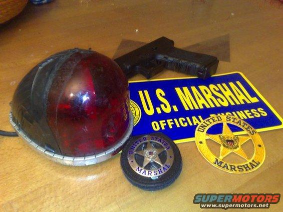U.S. Marshal badge, patch, and light bar with a handgun