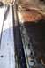 1992 Ford C-350 (Centurion Conversions) - The interior floor and door seal area of a white vehicle show significant rust and wear.