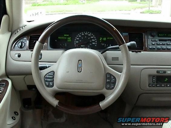 2002 Lincoln Town Car interior with wood-trimmed steering wheel and digital dashboard