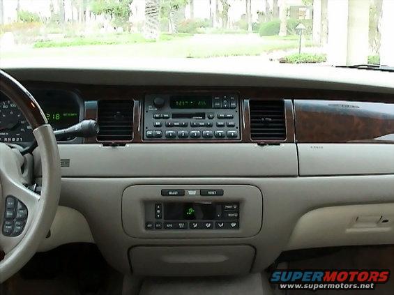 2002 Lincoln Town Car dashboard with wood trim, radio, and climate controls